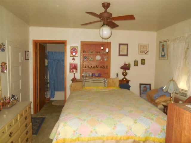 bedroom featuring a spacious closet, a closet, carpet flooring, and a ceiling fan