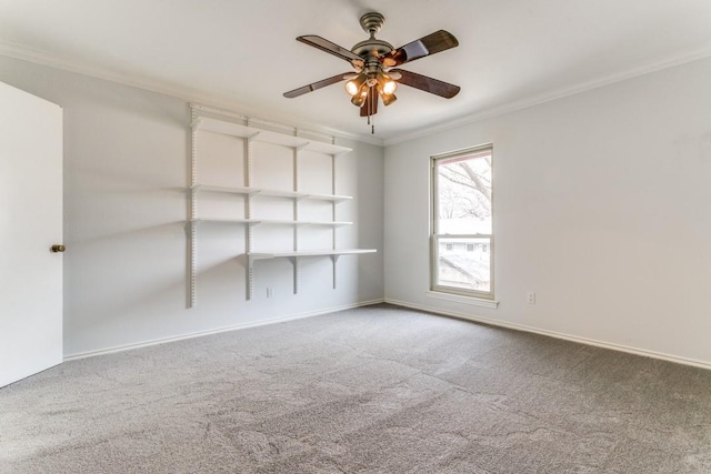 empty room featuring crown molding, baseboards, ceiling fan, and carpet flooring