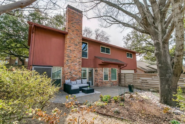 back of property with a patio, a chimney, fence, and an outdoor living space