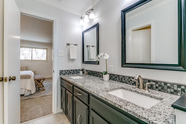 bathroom featuring double vanity, a sink, and crown molding