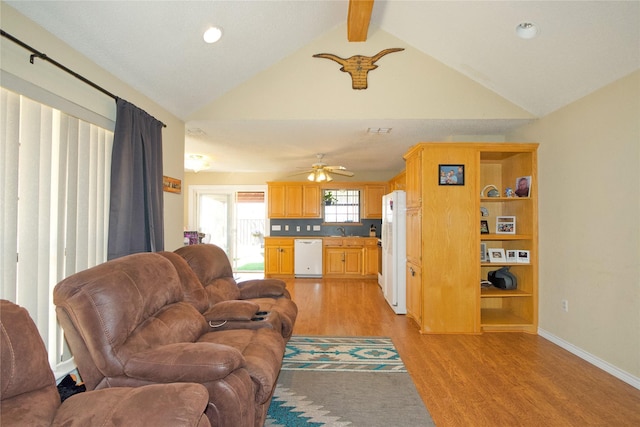 living room with lofted ceiling with beams, ceiling fan, visible vents, baseboards, and light wood-style floors