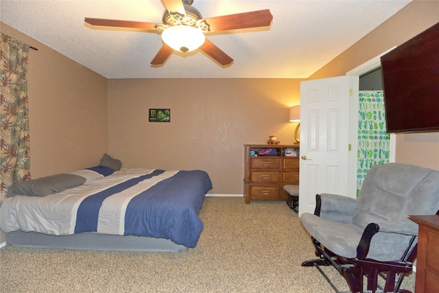 bedroom with light carpet, a textured ceiling, a ceiling fan, and baseboards