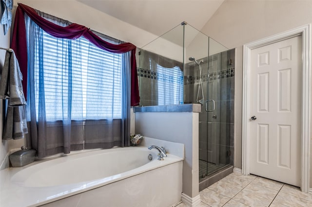 bathroom featuring a garden tub, a shower stall, and tile patterned floors