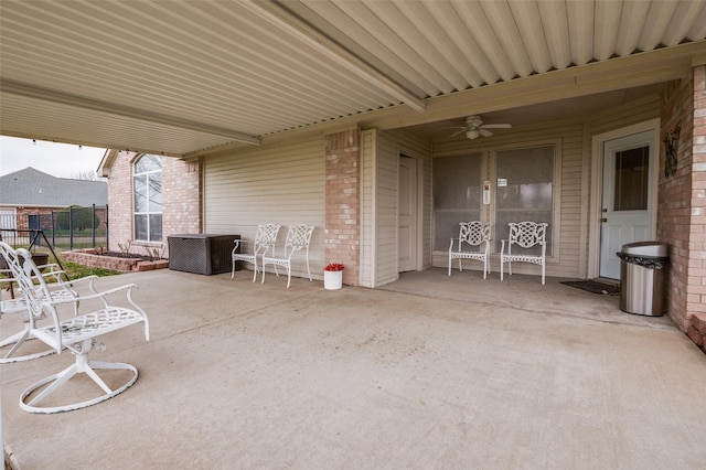 view of patio / terrace with fence and a ceiling fan