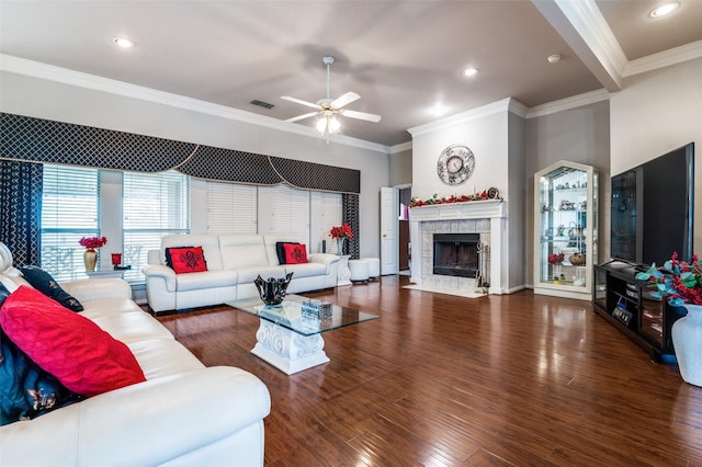 living area featuring crown molding, visible vents, and wood finished floors