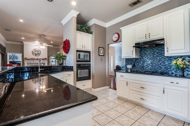 kitchen featuring visible vents, ornamental molding, a sink, under cabinet range hood, and black appliances