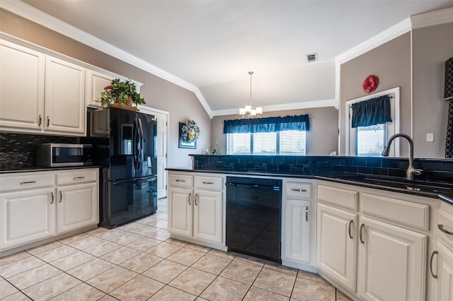 kitchen featuring lofted ceiling, a sink, black appliances, tasteful backsplash, and dark countertops