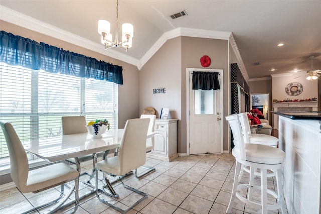 dining space with light tile patterned flooring, ceiling fan with notable chandelier, visible vents, vaulted ceiling, and ornamental molding