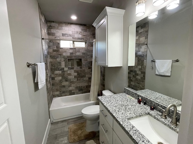 bathroom with toilet, shower / bath combo, vanity, wood finished floors, and baseboards