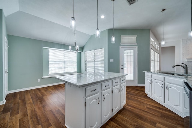 kitchen featuring a healthy amount of sunlight, white cabinetry, dark wood-style flooring, and a sink