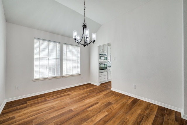 unfurnished dining area with lofted ceiling, a notable chandelier, baseboards, and dark wood-style flooring