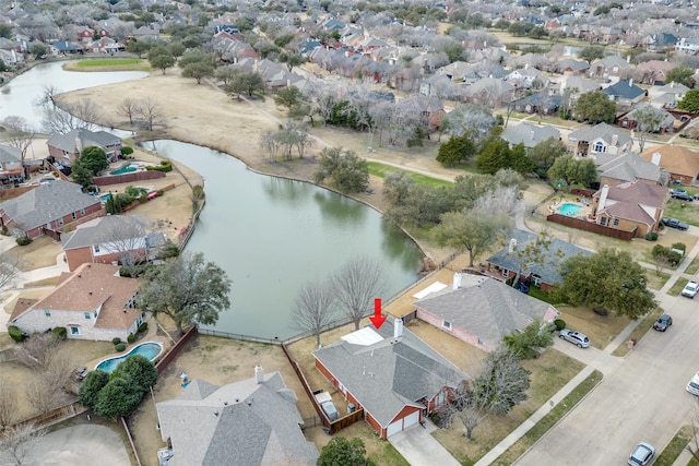 birds eye view of property with a water view and a residential view