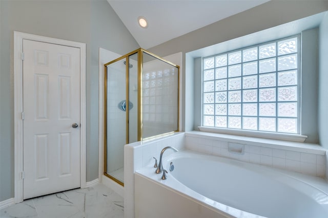 bathroom with marble finish floor, a garden tub, vaulted ceiling, a shower stall, and baseboards