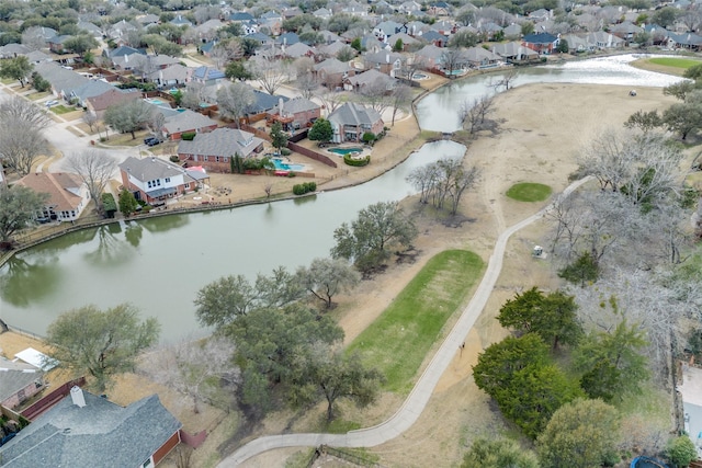 drone / aerial view with a water view and a residential view