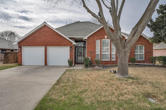 ranch-style house featuring driveway, brick siding, a front lawn, and roof with shingles