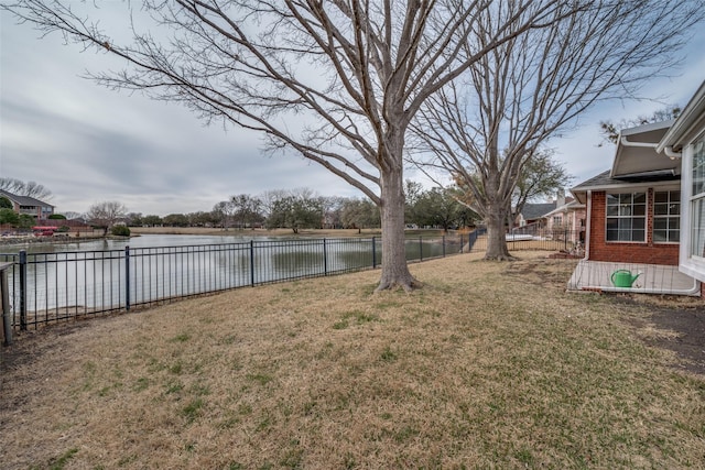 view of yard with a water view and a fenced backyard