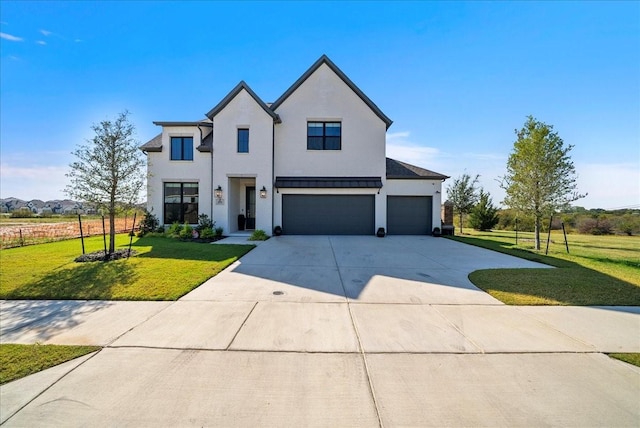 modern farmhouse featuring a garage, a front yard, concrete driveway, and stucco siding