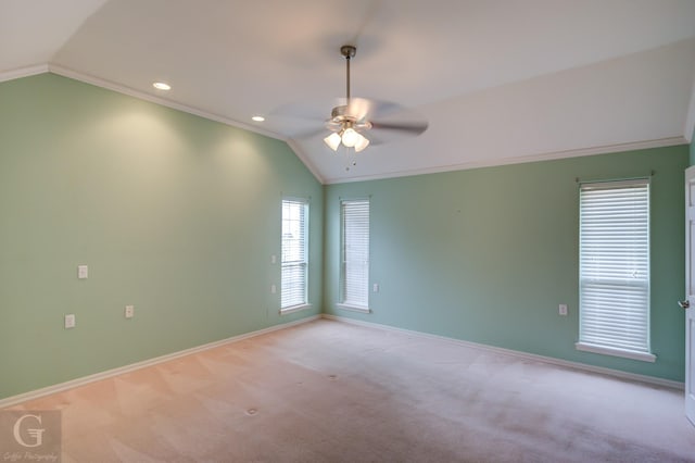 unfurnished room featuring lofted ceiling, ornamental molding, light carpet, and baseboards