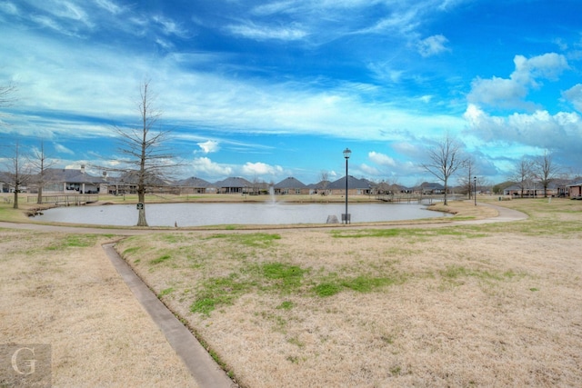 exterior space with a water view, a residential view, and street lights