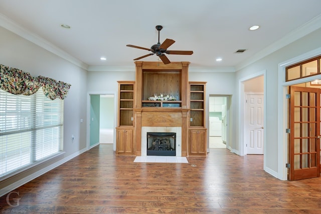 unfurnished living room featuring a large fireplace, visible vents, wood finished floors, crown molding, and recessed lighting