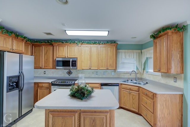 kitchen featuring visible vents, stainless steel appliances, a sink, and light countertops