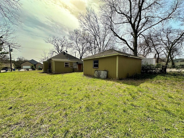 view of yard with fence and an outdoor structure