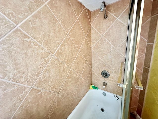 bathroom with bathing tub / shower combination