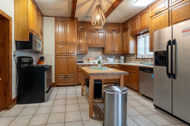 kitchen with light tile patterned floors, tasteful backsplash, wood counters, and appliances with stainless steel finishes