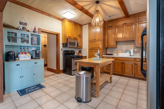 kitchen featuring stainless steel appliances, visible vents, beamed ceiling, and decorative backsplash