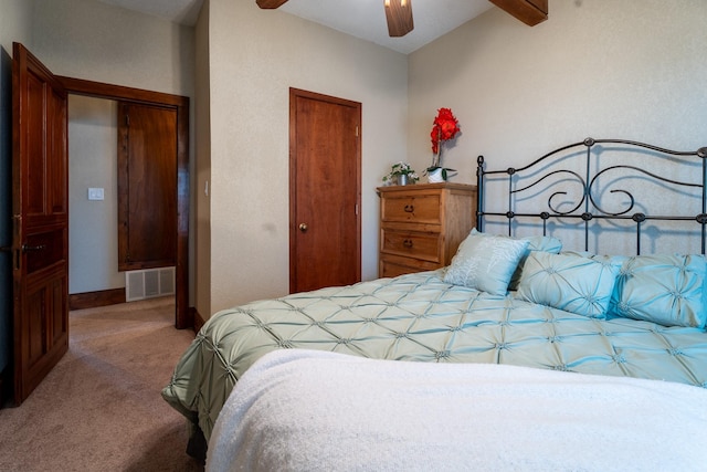 carpeted bedroom featuring a closet, visible vents, ceiling fan, and baseboards