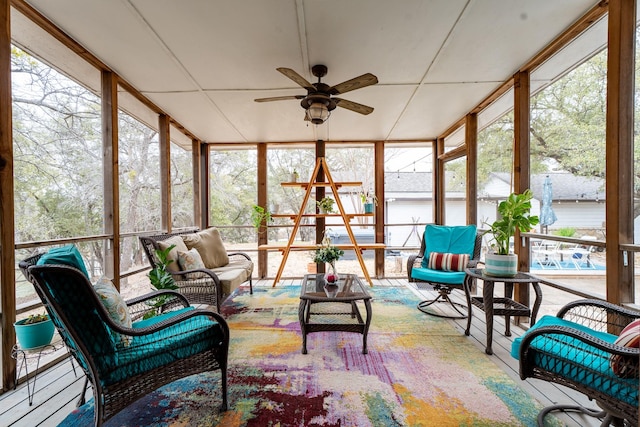 sunroom / solarium featuring a ceiling fan