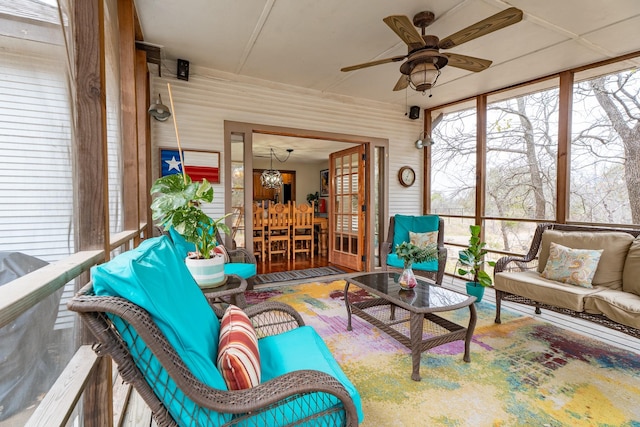 sunroom featuring a ceiling fan