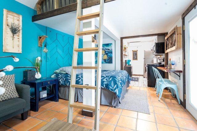 bedroom with light tile patterned floors, an accent wall, and a wall mounted AC