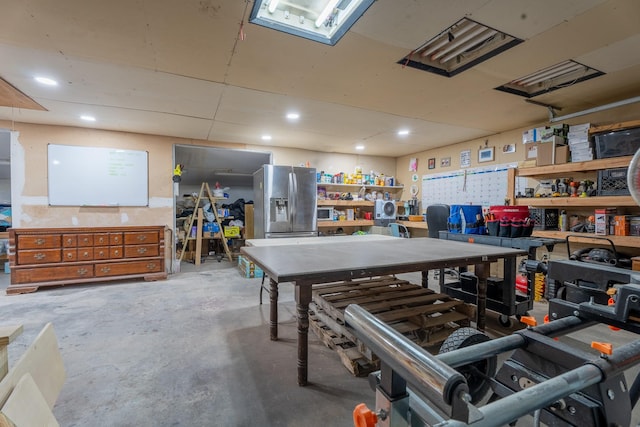 miscellaneous room featuring a workshop area and unfinished concrete flooring