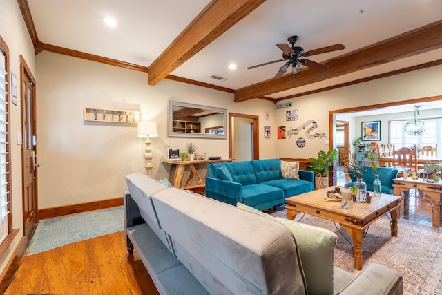 living room with recessed lighting, ornamental molding, wood finished floors, beamed ceiling, and baseboards