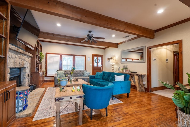 living area featuring recessed lighting, a fireplace, beamed ceiling, and wood finished floors