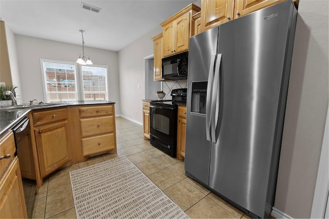 kitchen featuring light tile patterned flooring, visible vents, decorative backsplash, black appliances, and dark countertops