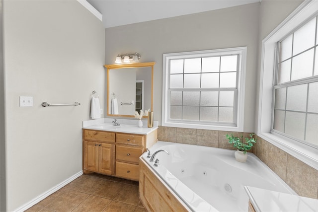 full bathroom featuring tile patterned floors, baseboards, a tub with jets, and vanity