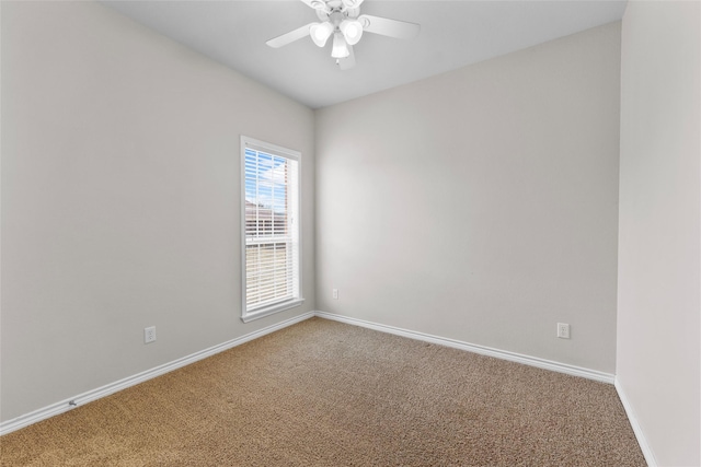 spare room featuring carpet floors, ceiling fan, and baseboards