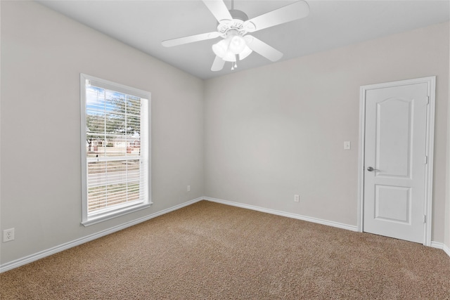 spare room with ceiling fan, carpet flooring, and baseboards