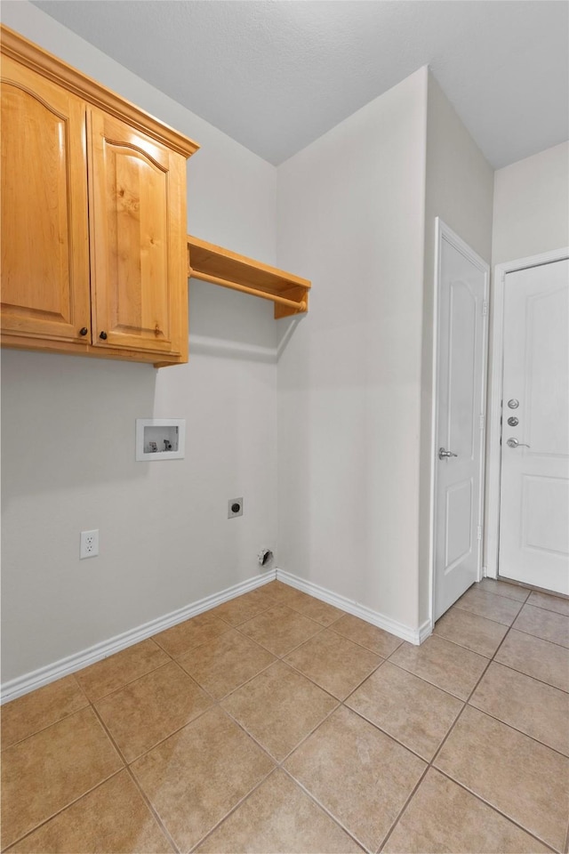 clothes washing area featuring washer hookup, cabinet space, light tile patterned flooring, hookup for an electric dryer, and baseboards