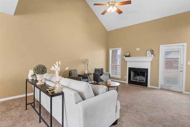 living area with high vaulted ceiling, carpet, a fireplace, and baseboards