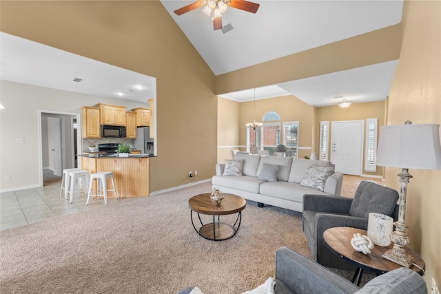 living room featuring high vaulted ceiling, light colored carpet, visible vents, and baseboards