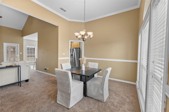 dining room featuring visible vents, ornamental molding, and light colored carpet