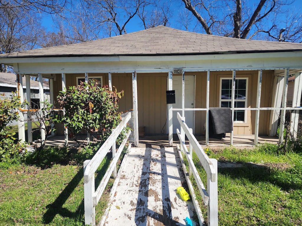 view of front of property with covered porch, a shingled roof, and board and batten siding