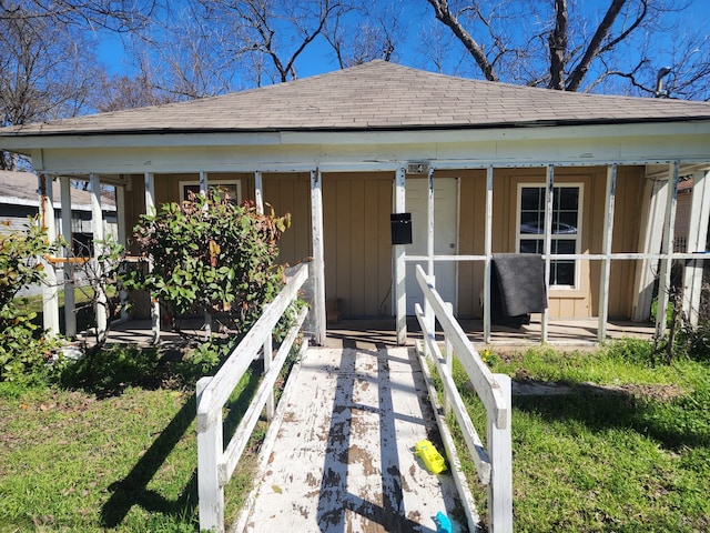 view of front of property with covered porch, a shingled roof, and board and batten siding