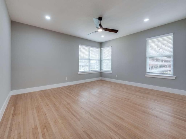 spare room featuring recessed lighting, baseboards, a ceiling fan, and light wood-type flooring
