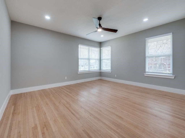 empty room featuring ceiling fan, light wood-style floors, recessed lighting, and baseboards