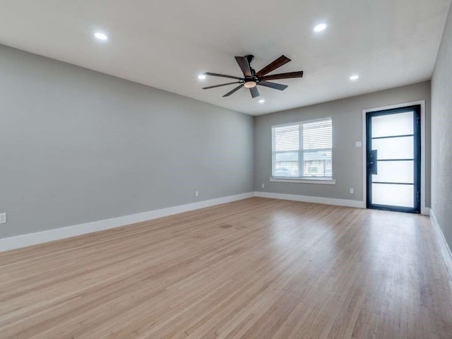 empty room featuring light wood finished floors, ceiling fan, baseboards, and recessed lighting