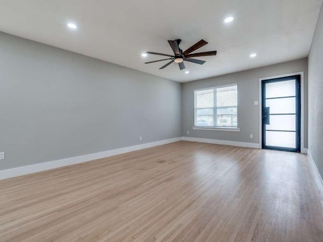 empty room featuring recessed lighting, ceiling fan, baseboards, and light wood finished floors